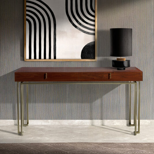 A minimalist room featuring the Luxury Walnut Veneer Console Table with brass legs, two handles, and a modern artwork above it. The artwork displays black-and-white geometric patterns, while a black cylindrical lamp with a gold-rimmed base sits on the right side of the table.