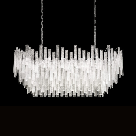 A rectangular piece combining modernity and elegance, the Modern Oval Glass Chandelier features elongated, textured glass tubes hanging vertically at varying heights. The fixture is suspended from two chains and is beautifully set against a black backdrop.