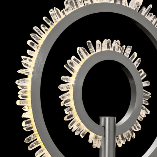Modern Quartz Crystal Hoop Nickel Table Lamp Close-up of a modern art sculpture featuring concentric metallic rings adorned with vertically oriented, illuminated crystals, reminiscent of the Modern Quartz Crystal Hoop Nickel Table Lamp. The pitch-black background accentuates the intricate details and glowing tips of the crystals.