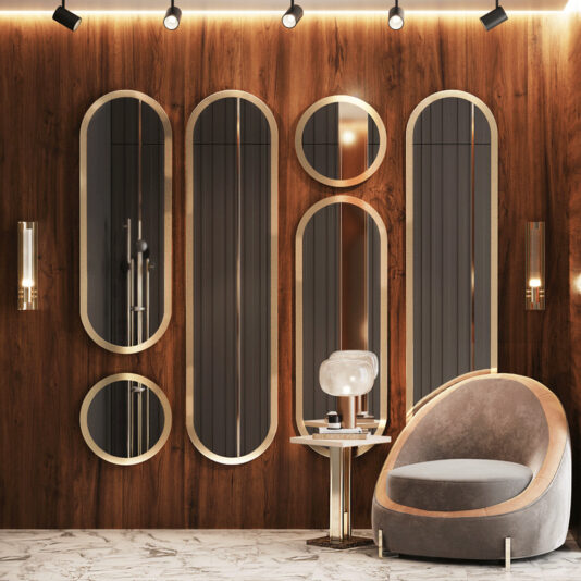 Luxurious interior with a modern armchair, a side table holding a lamp, and a wall adorned with tall oval mirrors and the elegant Round Modern Wall Mirror. Wood paneling and marble flooring add to the sophisticated decor, enhanced by soft, warm lighting.