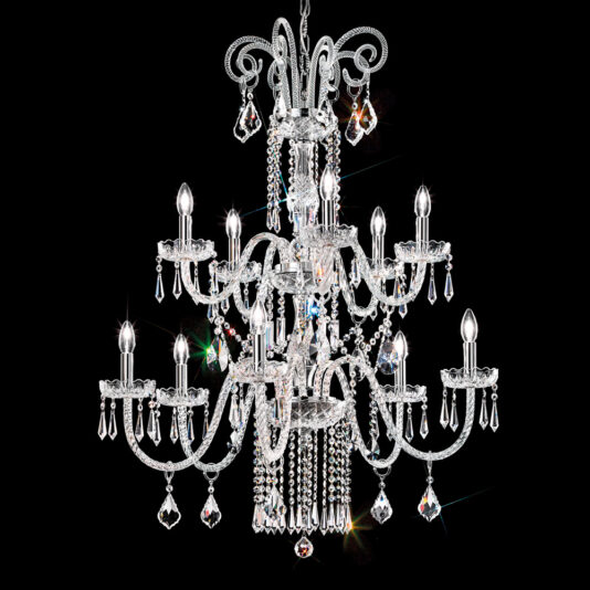 The Two Tier Blown Glass Chandelier With Crystals is a grand lighting fixture featuring multiple arms and tiers. It is adorned with sparkling blown glass pendants and crystals, each arm holding a candle-shaped light bulb. The chandelier emits a radiant glow against a dark background.