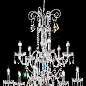 Two Tier Blown Glass Chandelier With Crystals A stunning Two Tier Blown Glass Chandelier With Crystals shines brilliantly against a black background. This elegant fixture, featuring numerous candle-like bulbs, is lavishly adorned with cascading crystal beads and pendants, exuding opulence and sophistication.