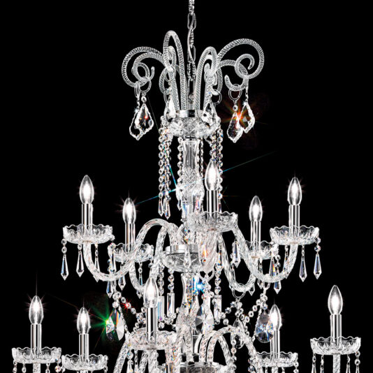 Two Tier Blown Glass Chandelier With Crystals A stunning Two Tier Blown Glass Chandelier With Crystals shines brilliantly against a black background. This elegant fixture, featuring numerous candle-like bulbs, is lavishly adorned with cascading crystal beads and pendants, exuding opulence and sophistication.