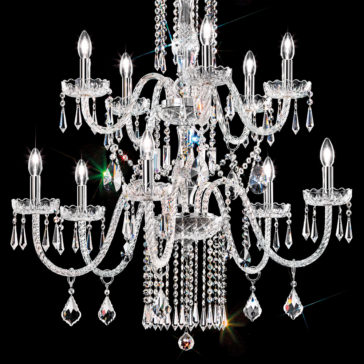 Two Tier Blown Glass Chandelier With Crystals The Two Tier Blown Glass Chandelier With Crystals exudes luxury with its numerous arms adorned with hanging crystals and candle-like bulbs, casting a bright white light against a black background. The chandelier sparkles vividly, creating a prism of colors reflected through the crystals.