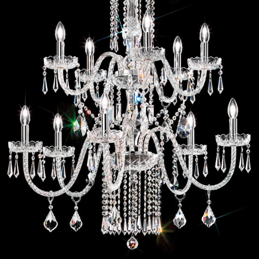 Two Tier Blown Glass Chandelier With Crystals The Two Tier Blown Glass Chandelier With Crystals exudes luxury with its numerous arms adorned with hanging crystals and candle-like bulbs, casting a bright white light against a black background. The chandelier sparkles vividly, creating a prism of colors reflected through the crystals.