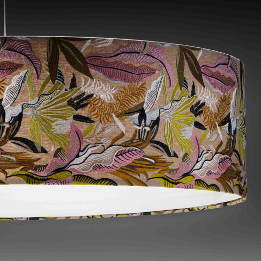 Elegant Suspension Light With Embroidered Shade The Elegant Suspension Light With Embroidered Shade hangs gracefully against a dark background. Its large cylindrical lampshade is adorned with a vibrant and intricate pattern of leaves and flowers in shades of pink, yellow, green, brown, and white, creating a tropical and colorful appearance.