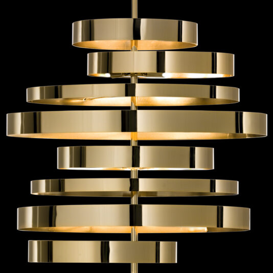 Large Contemporary Chandelier The Large Contemporary Chandelier features concentric golden metallic rings of various sizes, arranged symmetrically to create a stunning centerpiece. These rings emit a warm glow, set against a striking black background.