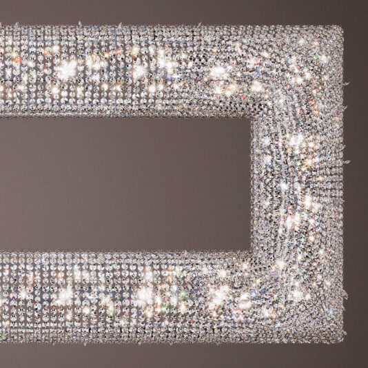 Luxury High End Crystal Chandelier A close-up of a rectangular, crystal-studded frame with ornate detailing. The Luxury High End Crystal Chandelier is adorned with numerous sparkling crystals, reflecting light in various colors, creating a glittering, high-end appearance reminiscent of a chandelier against a muted background.