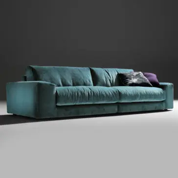 Luxury Large Velvet Modular Sofa The Luxury Large Velvet Modular Sofa in modern teal is set against a dark background, featuring plump cushions and armrests on both sides. This sophisticated sofa is complemented by two decorative pillows, including one in dark blue with a subtle pattern, enhancing its sleek and elegant design.
