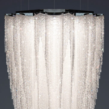 The Luxury Suspended Crystal Pendant Chandelier, with its multi-tiered cascading crystal strands, beautifully reflects light to create a dazzling and elegant look against dark backgrounds.