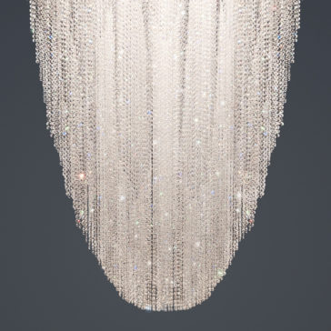 The Luxury Suspended Crystal Pendant Chandelier features numerous cascading strands of sparkling crystals arranged in an elongated oval shape, hanging against a grey background. The crystals reflect light brilliantly, resulting in a dazzling display.