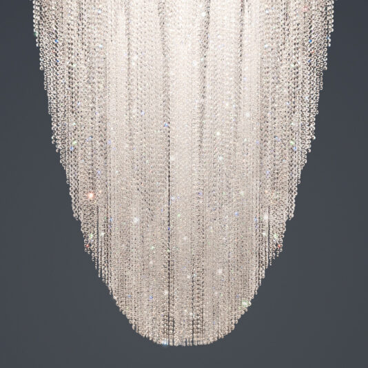 Luxury Suspended Crystal Pendant Chandelier The Luxury Suspended Crystal Pendant Chandelier features numerous cascading strands of sparkling crystals arranged in an elongated oval shape, hanging against a grey background. The crystals reflect light brilliantly, resulting in a dazzling display.