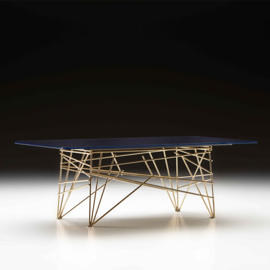 The Modern Rectangular Glass Coffee Table features a sleek dark glass top and a distinctive base composed of intersecting gold metal rods, forming an airy geometric pattern. Set against a dark gradient background, the table exudes contemporary and artistic flair.