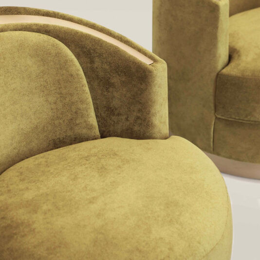 Modern Swivel Tub Chair A close-up shot of two Modern Swivel Tub Chairs in green velvet. The chairs showcase smooth curves and a plush texture, with part of the backrests and seats visible. The luxurious green velvet material gives the furniture a cozy and high-end appearance.