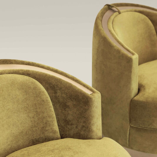 Modern Swivel Tub Chair Two Modern Swivel Tub Chairs in a curved design, upholstered in olive-green velvet with plush cushions and armrests, are showcased against a neutral background. These chairs feature sleek lines and embody a minimalist aesthetic.
