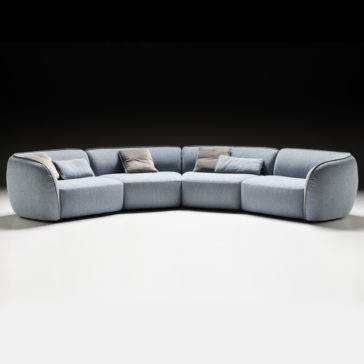 Contemporary Bouclè Modular Corner Sofa The Contemporary Bouclè Modular Corner Sofa, featuring a modern light blue color, rounded edges, and multiple cushions, sits on a white floor against a dark background. Its minimalist design showcases soft curves and plush seating for a contemporary aesthetic.