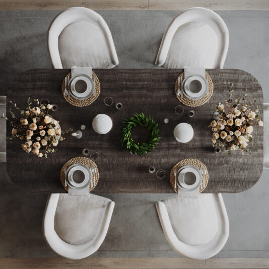 Large Modern Ribbed Veneer Dining Table A chic dining table set for four, viewed from above. The Large Modern Ribbed Veneer Dining Table is beautifully adorned with white plates, woven placemats, white napkins, and elegant flower arrangements at each end. A green wreath centerpiece and white pottery add a touch of sophistication. White cushioned chairs surround the table.