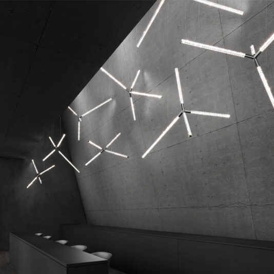 Luxury Crystal LED Chandelier A room with a concrete wall is elevated by the opulent glow of the Luxury Crystal LED Chandelier.