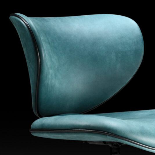 Retro Inspired Swivel Office Chair A close-up view of the Retro Inspired Swivel Office Chair, showcasing its modern blue-green design against a black background. This chair features sleek, curved lines and a softly cushioned leather backrest and seat, with elegant black trim outlining the edges.