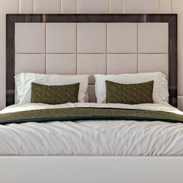 Art Deco Style Bed With Tall Headboard An elegantly designed Art Deco Style Bed With Tall Headboard features a large, tufted beige headboard and a dark wooden frame. The bed is adorned with white sheets and two large white pillows, accentuated by two decorative brown and gold patterned pillows placed at the front. A matching throw blanket rests gracefully at the foot of this sophisticated bed.
