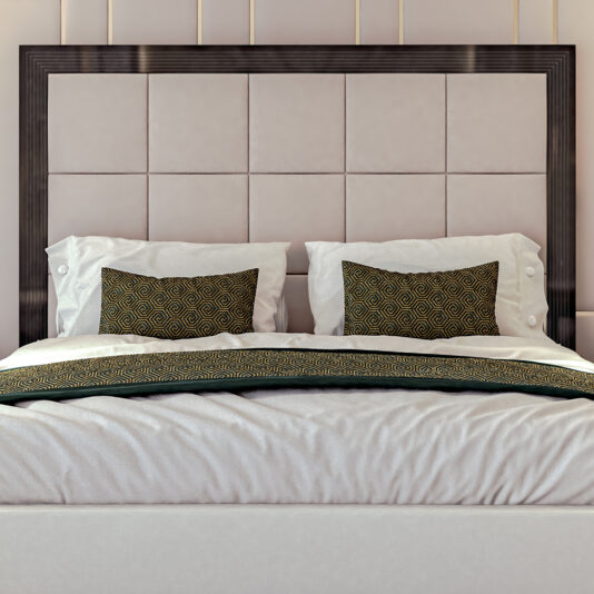 Art Deco Style Bed With Tall Headboard An elegantly designed Art Deco Style Bed With Tall Headboard features a large, tufted beige headboard and a dark wooden frame. The bed is adorned with white sheets and two large white pillows, accentuated by two decorative brown and gold patterned pillows placed at the front. A matching throw blanket rests gracefully at the foot of this sophisticated bed.