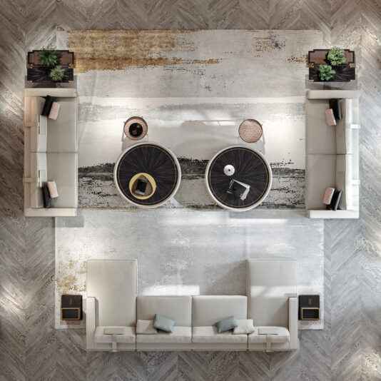 High End Art Deco Style Sofa An overhead view of a modern living room featuring the High End Art Deco Style Sofa, two round coffee tables, a textured rug, and decorative plants. The furniture is symmetrically arranged on a herringbone-patterned wood floor.