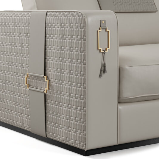 High End Art Deco Style Sofa Get a close-up view of the High End Art Deco Style Sofa, showcasing its intricate woven patterns, metallic accents, and tassel decorations on the arm. The light gray upholstery with detailed textures creates an elegant and sophisticated design.