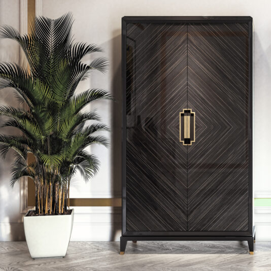 A modern, sleek black High-End Veneer Wardrobe Cabinet with a geometric pattern and gold handles stands beside a tall potted indoor plant with lush, green fronds. The room features light walls with subtle decorative molding and a herringbone-patterned wood floor.