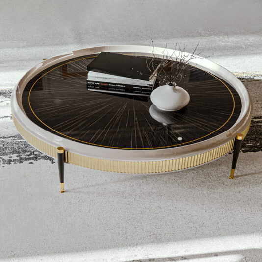 A High End Veneered Low Round Coffee Table with a black and gold patterned top stands on a black and beige floor. Four books and a small white vase containing dry branches adorn the table. The modern piece, featuring a white and gold frame with slender black legs, exudes stylish elegance.