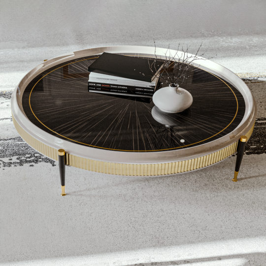 A High End Veneered Low Round Coffee Table with a black and gold patterned top stands on a black and beige floor. Four books and a small white vase containing dry branches adorn the table. The modern piece, featuring a white and gold frame with slender black legs, exudes stylish elegance.