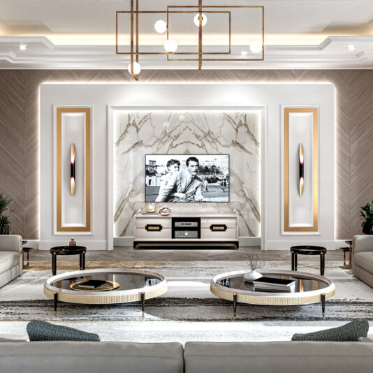 High End Veneered Low Round Coffee Table A luxurious living room features a large TV mounted on a marble wall displaying a black-and-white movie. The room boasts modern furniture, including two High End Veneered Low Round Coffee Tables and cream-colored sofas. Elegant light fixtures hang from the ceiling, illuminating the space.