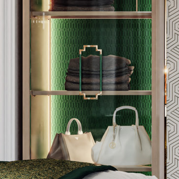 Large High End Integrated Wardrobe The Large High End Integrated Wardrobe showcases a display shelf with a gold frame, featuring neatly folded dark towels and two elegant handbags—one white and one beige—set against a textured green background. The design of the shelf includes geometric metal handles, while part of a patterned wall can be seen on the right.