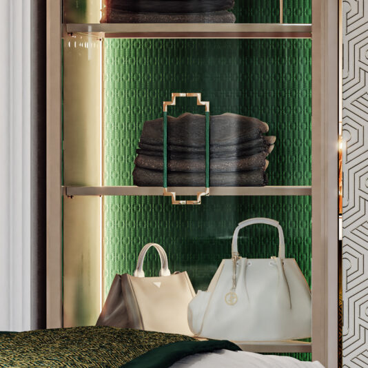 Large High End Integrated Wardrobe The Large High End Integrated Wardrobe showcases a display shelf with a gold frame, featuring neatly folded dark towels and two elegant handbags—one white and one beige—set against a textured green background. The design of the shelf includes geometric metal handles, while part of a patterned wall can be seen on the right.