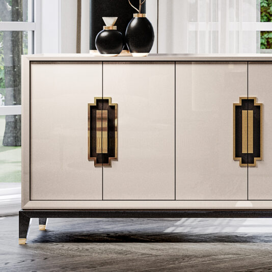 Large High End Lacquered Sideboard A large High End Lacquered Sideboard in sleek modern white, highlighted with gold and black geometric handles, stands elegantly against a window draped with sheer white curtains. Adorning the top of this chic piece are two black vases with gold necks and a decorative black object.