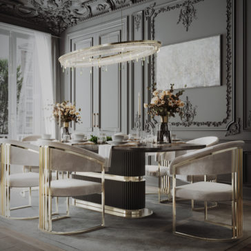 Modern Art Deco Style Curved Dining Chair A luxurious dining room featuring an elegant round table with a black base and a white top, surrounded by six plush Modern Art Deco Style Curved Dining Chairs in beige with gold accents. A large, ornate chandelier hangs overhead. The space is inspired by modern Art Deco style and is adorned with intricate wall moldings, a large window, and floral arrangements.