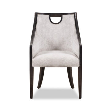 The Modern Walnut Luxury Dining Chair showcases a sleek walnut frame with elegantly curved arms and legs. It features a smooth, light gray upholstered seat and backrest, enhanced by a stylish cut-out handle at the top of the backrest.