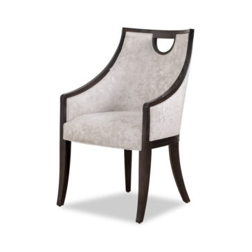 The Modern Walnut Luxury Dining Chair boasts a dark walnut frame and soft, light gray upholstered cushions on the seat and back. Its curved arms and distinctive cut-out design near the top of the backrest add elegance, while slightly tapered legs make it a luxurious addition to any dining space.