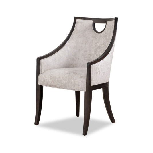 Modern Walnut Luxury Dining Chair The Modern Walnut Luxury Dining Chair boasts a dark walnut frame and soft, light gray upholstered cushions on the seat and back. Its curved arms and distinctive cut-out design near the top of the backrest add elegance, while slightly tapered legs make it a luxurious addition to any dining space.