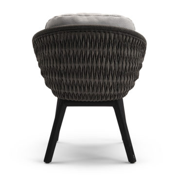 The rear view of the Contemporary Outdoor Woven Dining Chair showcases its modern design, featuring a rounded back and black wooden legs. The light gray seat cushion provides a striking contrast to the darker, textured weave of the chair, emphasizing both comfort and contemporary style.