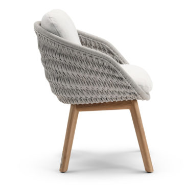 A side view of the Contemporary Outdoor Woven Dining Chair showcases its cushioned seat in light grey fabric. The chair features a sturdy wooden frame with four legs, embodying a stylish and comfortable design perfect for both indoor and outdoor settings.