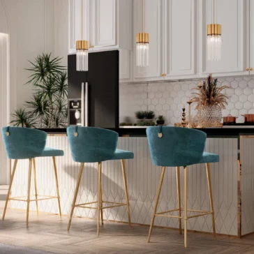 Contemporary Glass Tube Pendant Light A modern kitchen features a black countertop paired with three teal and gold bar stools. White cabinets contrast a sleek black refrigerator, illuminated by the Contemporary Glass Tube Pendant Light. Potted plants add greenery, while the floor showcases a wood-patterned finish.