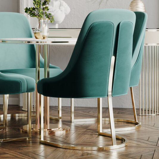 A modern dining area adorned with High End Contemporary Dining Chairs in teal velvet, distinguished by their gold legs, elegantly arranged around a sleek table. The setting is complemented by decorative accents including a small vase with flowers and minimalist ceramic pieces, all beautifully staged on a chevron-patterned wooden floor against a neutral wall.
