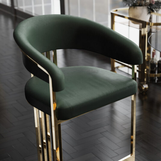 Modern Art Deco Style Curved Bar Stool A stylish Modern Art Deco Style Curved Bar Stool in green, featuring a curved backrest and armrests, is set on a golden metal frame. Positioned on a dark wooden floor, the bar stool shares the space with a window and a trolley holding decorative items in the blurred background.