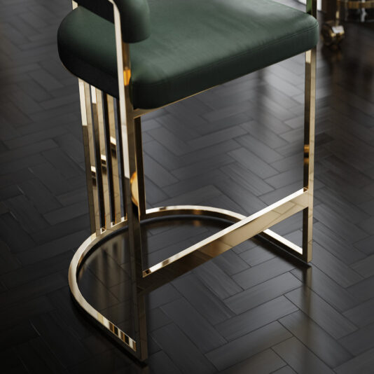 Modern Art Deco Style Curved Bar Stool A close-up of a Modern Art Deco Style Curved Bar Stool with a green cushion, featuring a sleek gold metal frame. The stool is placed on a dark, herringbone-patterned wooden floor, which adds contrast and highlights the elegant design of the bar stool.