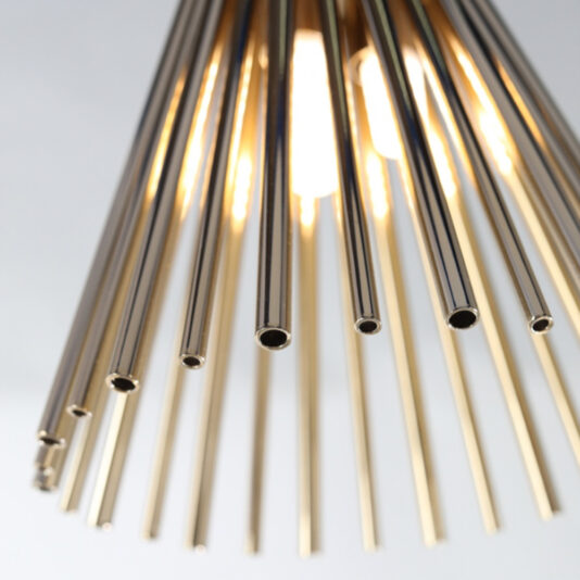 Modern Gold Plated Pendant Light Close-up of the Modern Gold Plated Pendant Light, featuring cylindrical rods radiating outward from a central source of light, creating a sunburst effect. The rods have a shiny metallic finish, and the light glows softly through the gaps.