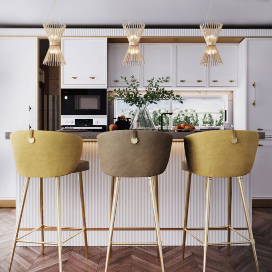 Modern Gold Plated Pendant Light A contemporary kitchen with a white color palette showcases a marble-top island. Positioned at the island are three tall stools featuring green and brown upholstery paired with gold legs. Hanging overhead are three Modern Gold Plated Pendant Lights, adorned with intricate designs. The counter is decorated with plants and various kitchenware items.