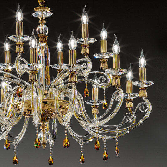 Candelabra Style Chandelier With Swarovski Crystals A luxurious Candelabra Style Chandelier With Swarovski Crystals hangs against a dark background, featuring multiple candle-shaped lights and ornate detailing. Delicate glass prisms and amber Swarovski crystal accents are interspersed, reflecting light and adding elegance to the fixture.