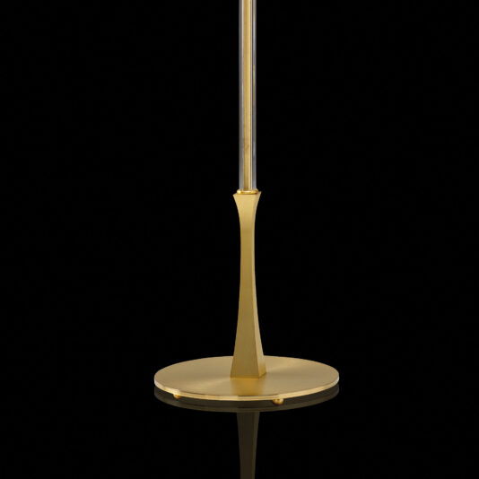 Elegant Glass Floor Lamp A close-up view of the base of the Elegant Glass Floor Lamp reveals its sleek, modern design. The circular and metallic base gleams with a luxurious gold finish, reminiscent of an elegant glass table lamp. A sophisticated pole ascends gracefully from the center. Against a pitch-black background, the golden base stands out brilliantly.