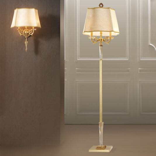 Introducing the Luxury Classical Floor Lamp, paired with a matching wall sconce. Both boast elegant metallic gold finishes and beige fabric shades. The floor lamp features a tall, slender base, while the wall sconce showcases ornate design elements. These pieces are perfectly suited against a richly textured wall and paneled background, adding sophistication to any space.