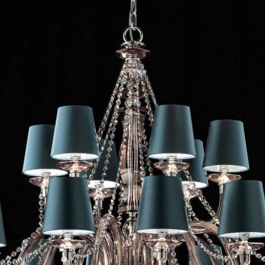 The Large Modern Smoked Glass Chandelier With Shades features multiple tiers of teal lampshades and ornate crystal chains, elegantly hanging against a black background. Its intricate design includes polished metal arms and delicate smoked glass details, creating an elegant and sophisticated appearance.